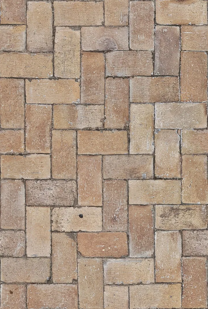 Warm-toned rectangular pavers in an interlocking pattern