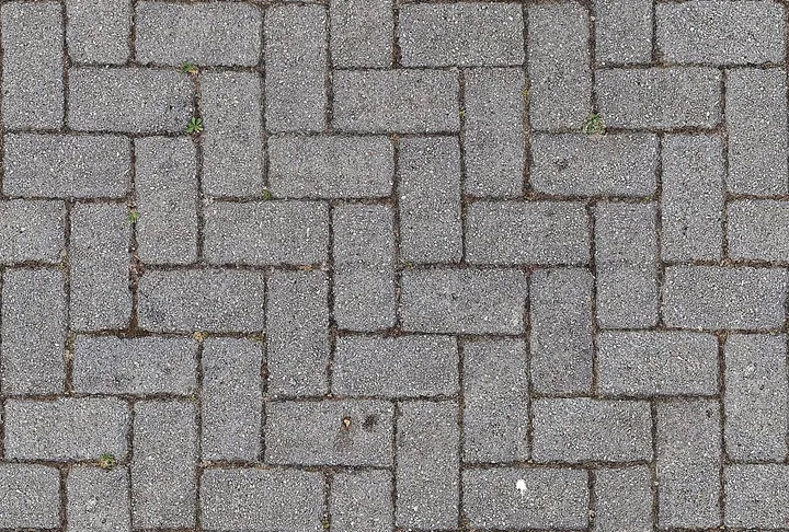 A grey interlocking paver surface